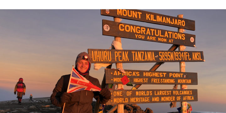 Luke at the top of the Mount Kilimanjaro