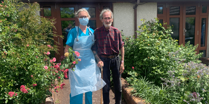 David Fuller and nurse picking flowers