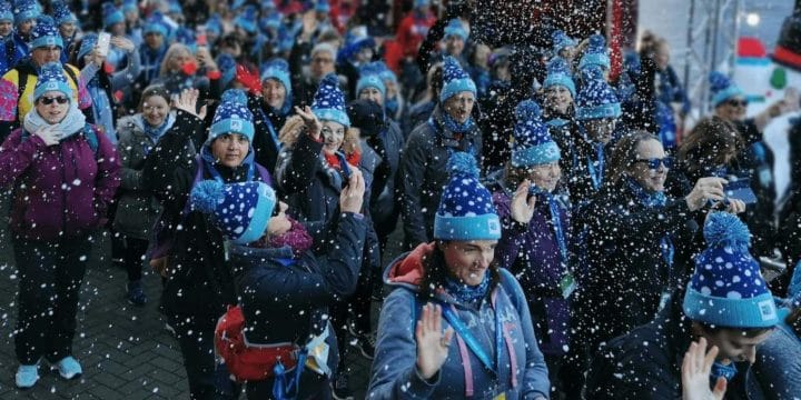 a large group of participants in blue bobble hats setting off on the London winter walk