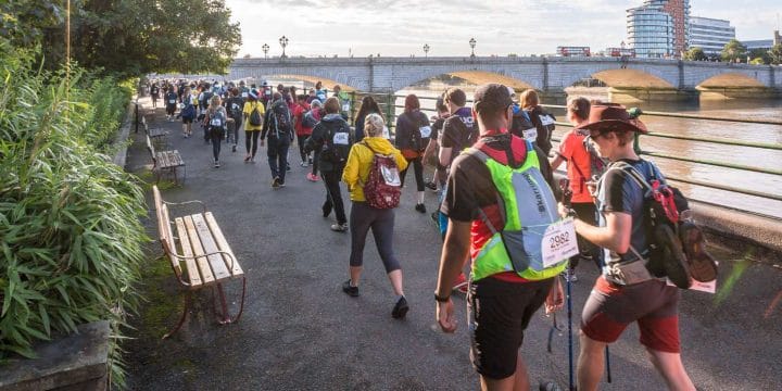 Group fo walkers trekking along the path of the River Thames