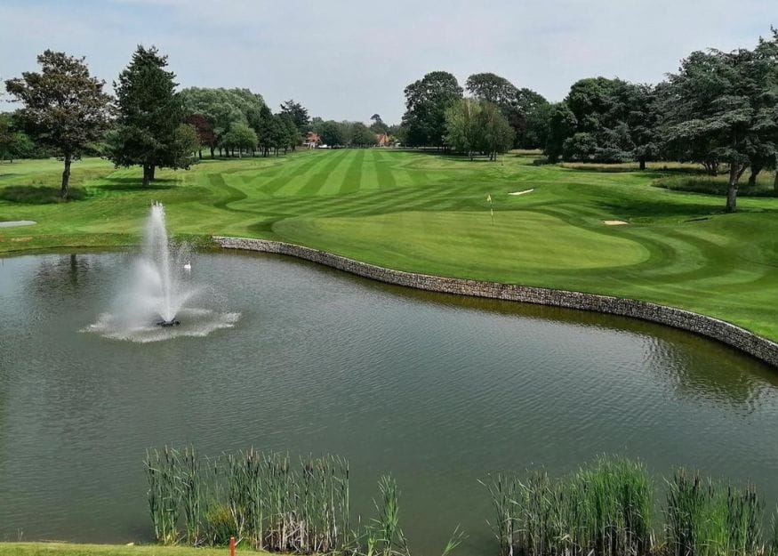 ham manor golf club with pond and fountain in the foreground